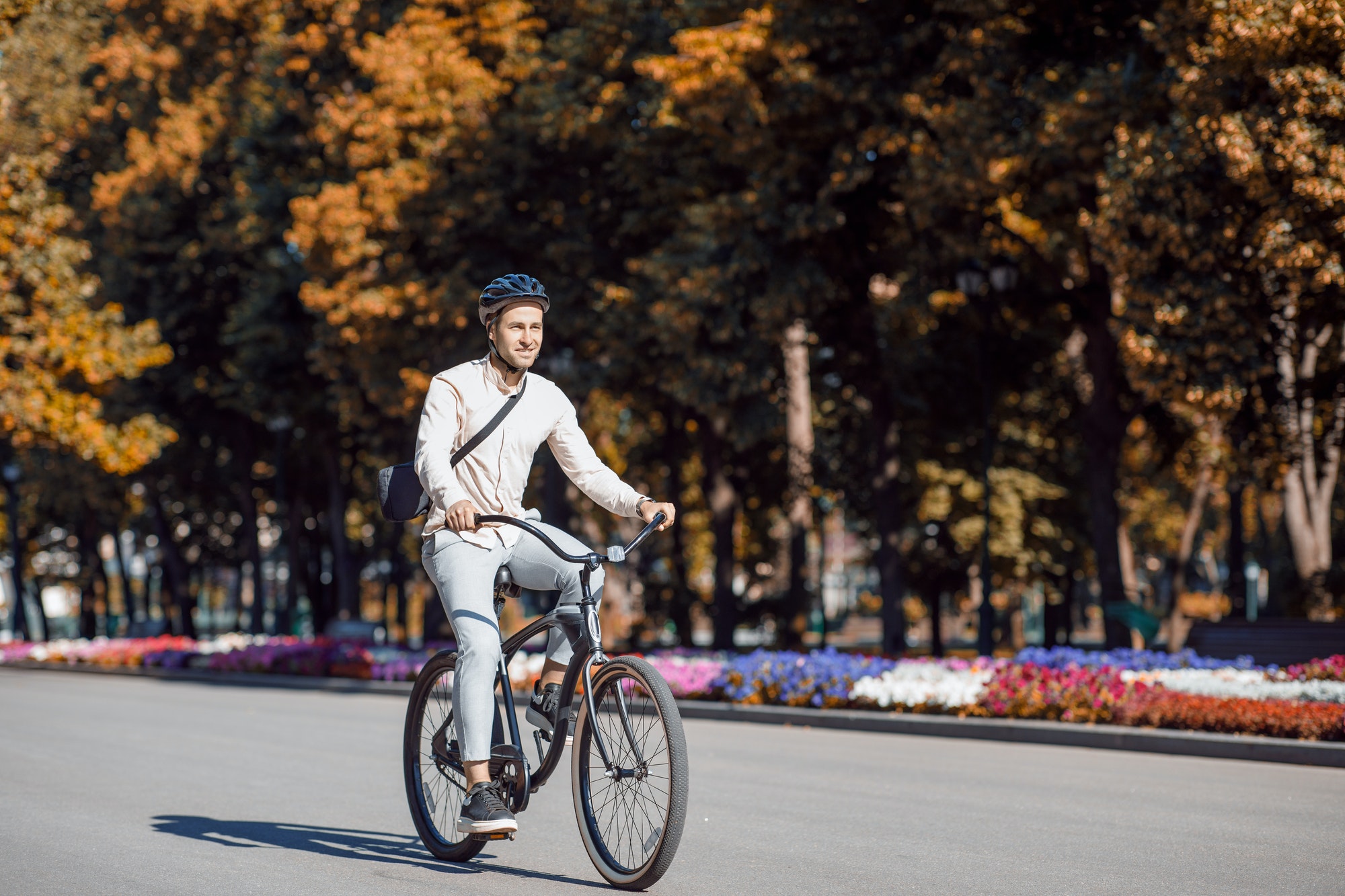 Urban eco transport. Handsome hipster in helmet enjoying bike